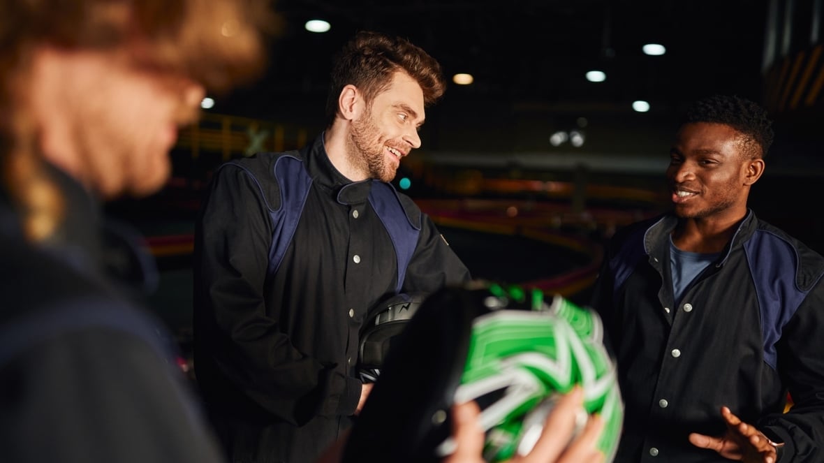 cheerful-multicultural-men-chatting-inside-of-kart-2024-11-09-02-23-19-utc