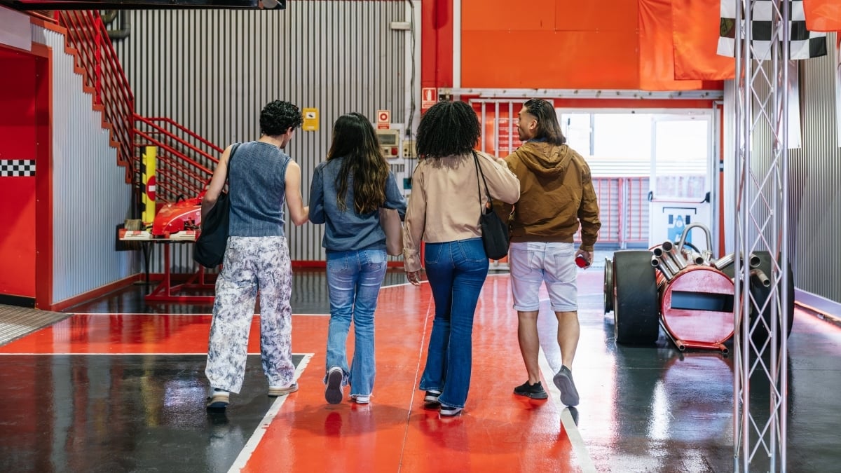 friends-walking-in-go-kart-track-leisure-facility-2025-10-27-21-43-56-utc